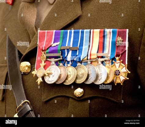 A row of campaign medals including the George Cross pinned on a British army officers uniform ...