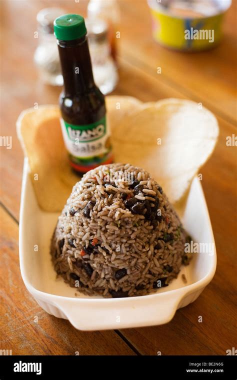 Lizano sauce being poured onto a plate of Gallo Pinto, a typical and traditional dish in Costa ...