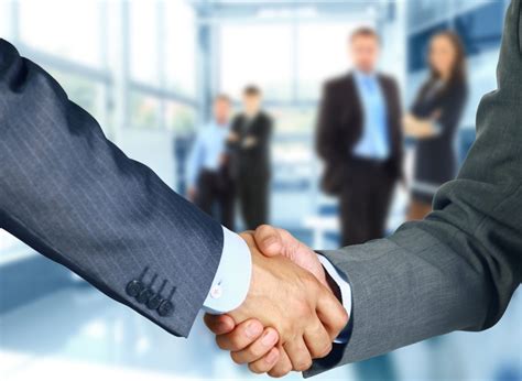 Business associates shaking hands in office - FLAWMA.org