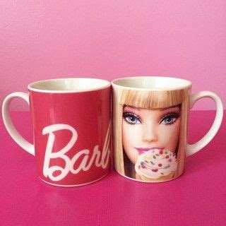 two coffee mugs with barbie's face and donuts on them, one is pink