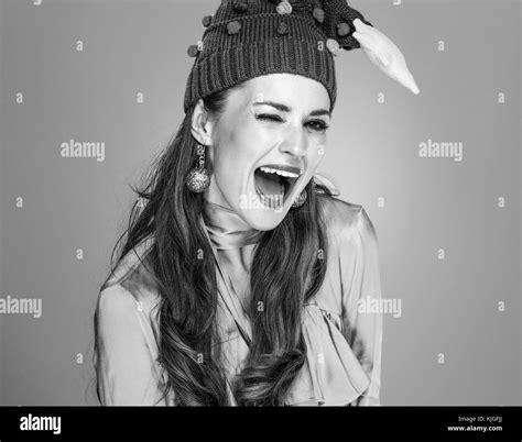 Stunning season. smiling young woman in funny Christmas hat isolated on grey winking Stock Photo ...
