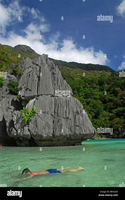 Snorkeling tourist in a bay in El Nido area, Palawan, Philippines, Southeast Asia Stock Photo ...