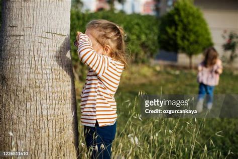 Kids Playing Hide And Seek Outside Photos and Premium High Res Pictures ...