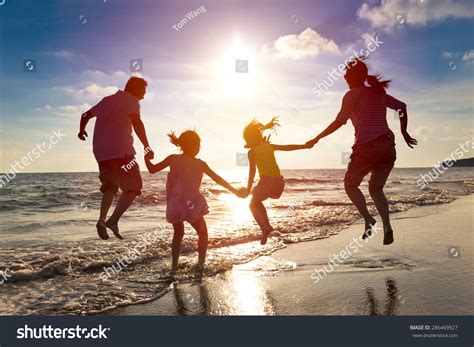 Happy Family Jumping Together On Beach Stock Photo 286469927 | Shutterstock