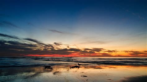 Download wallpaper 3840x2160 ocean, sunset, horizon, sand, silhouettes, california 4k uhd 16:9 ...