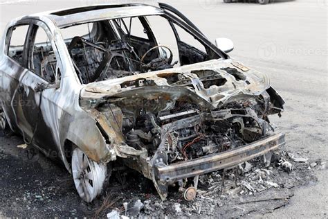 Burnt out car on the road 9219369 Stock Photo at Vecteezy