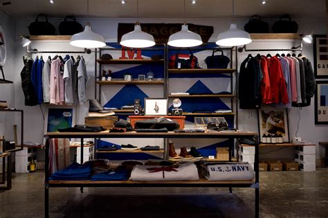 racks with mens apparel on the walls of a clothes store, store organization 4k HD Wallpaper