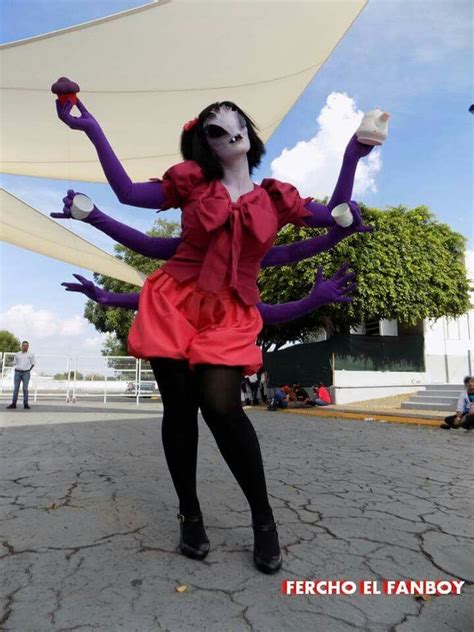 a woman dressed up as a monster with her hands in the air and legs out