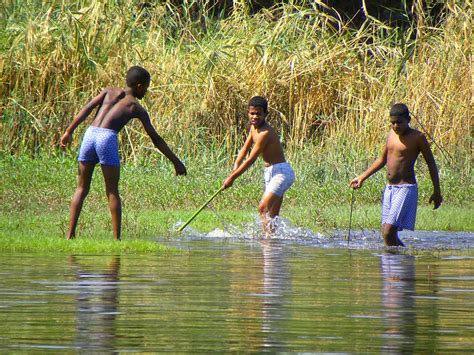 Egyptian Boys Fishing In The Nile Photograph by Teresa Stewart