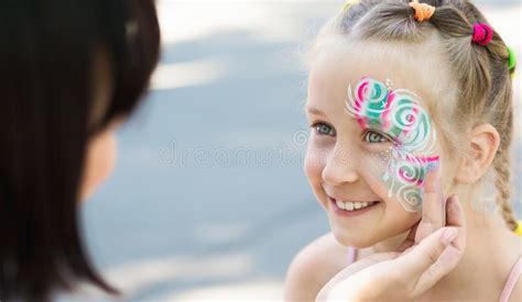 Little Girl Getting Her Face Painted by Face Painting Artist. Stock Image - Image of bright ...