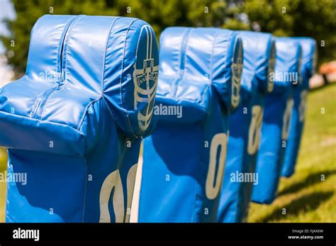 Football practice tackling and blocking dummies on a training sled ...