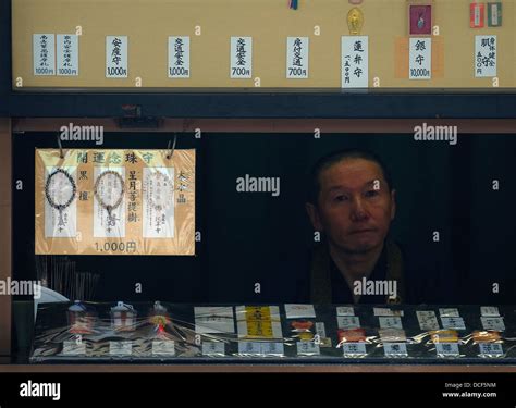 Buddhist monk selling lucky charms, Sensoji temple Stock Photo - Alamy