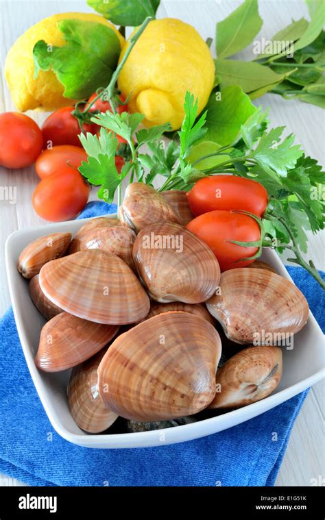 raw sea fruits called fasolari live again with lemon Stock Photo - Alamy