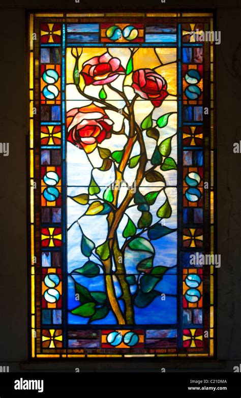 Antique stained glass window of roses on the vine, surrounded by ying/yang symbols Stock Photo ...