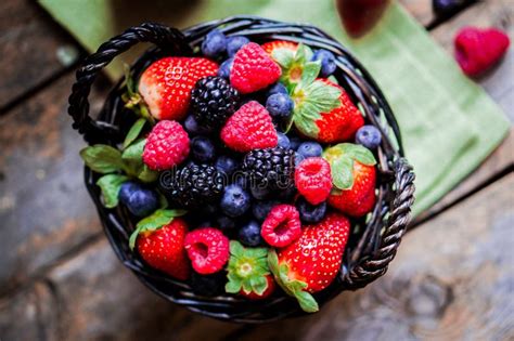 Mix of Fresh Berries in a Basket on Rustic Wooden Background Stock Photo - Image of close ...