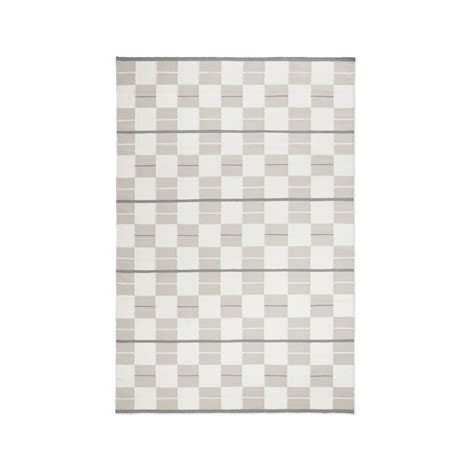 a gray and white rug with squares on the bottom, in front of a white background