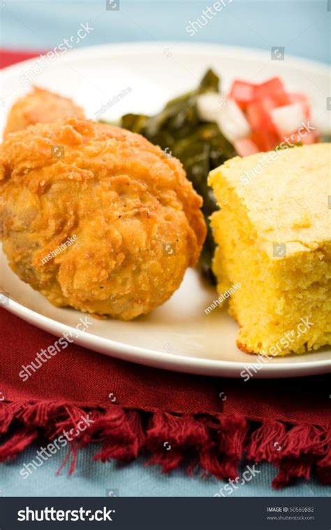 Fried Chicken Served With Collard Greens And Cornbread Stock Photo ...