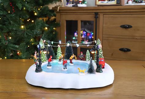 Christmas Concepts® 30cm Battery Operated Musical LED Animated Ice Rink Village Scene - Plays 8 ...