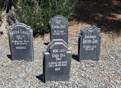 three headstones are placed in the gravel