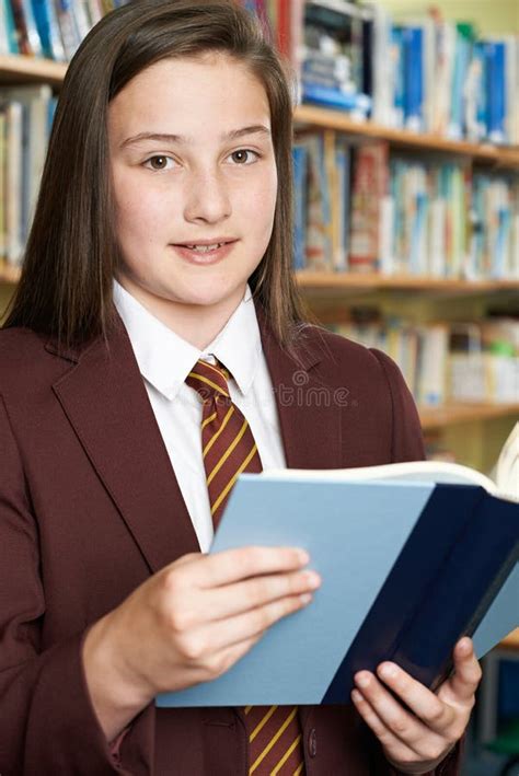 Girl Wearing School Uniform Reading Book in Library Stock Image - Image ...