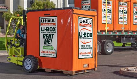 Couple loading a U-Box® container in their driveway