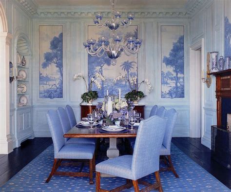 a dining room with blue chairs and a chandelier