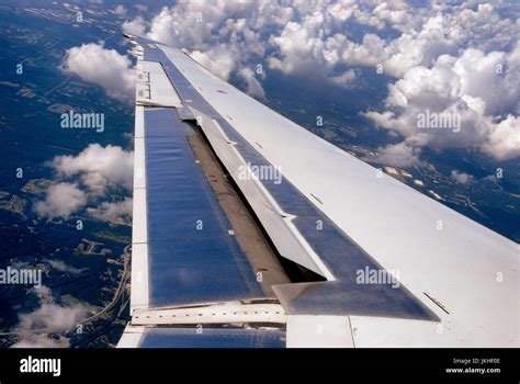 Aileron of a airplane wing during flight Stock Photo - Alamy