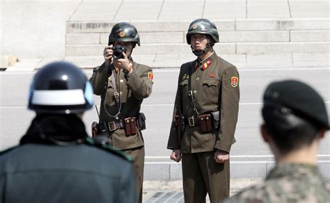 South Korea guards fire 20 warning shots to protect defector from pursuing North Korean troops