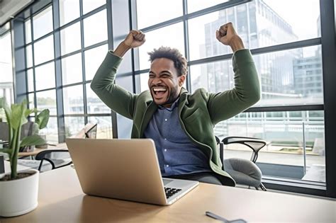 Premium AI Image | Happy young businessman with laptop in office