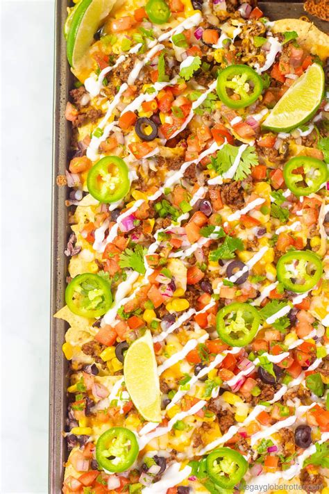 These simple sheet pan loaded nachos have all the best toppings like beef and black beans ...