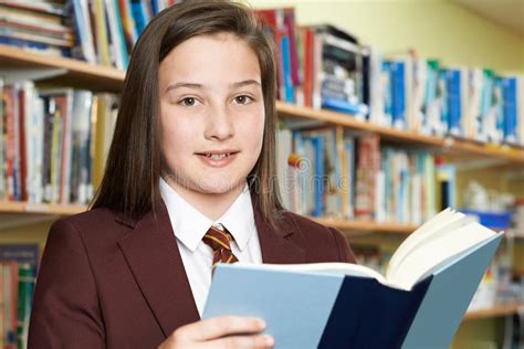 Girl Wearing School Uniform Reading Book in Library Stock Image - Image ...