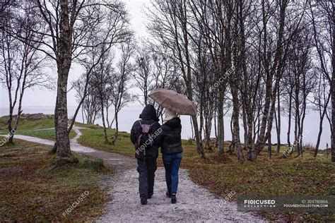 Friends walking on park path near sea — destination, journey - Stock Photo | #324780866