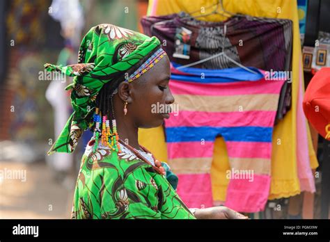 BOHICON, BENIN - JAN 12, 2017: Unidentified Beninese woman in green dress and headscarf looks ...