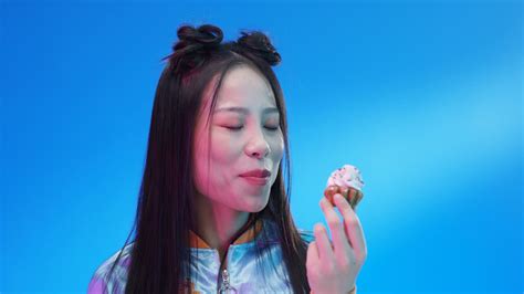 Free stock video - Close up of woman eating little cupcake with pink cream