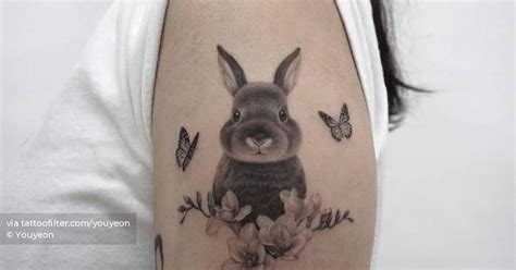 Micro-realistic rabbit tattoo on the upper arm.