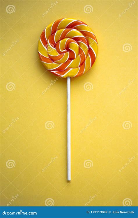 Bright Swirl Lollipop on Yellow Background Stock Image - Image of ...