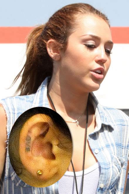 Miley Cyrus Love Tattoo in Her Ear - Pics, Story and Meaning Behind It