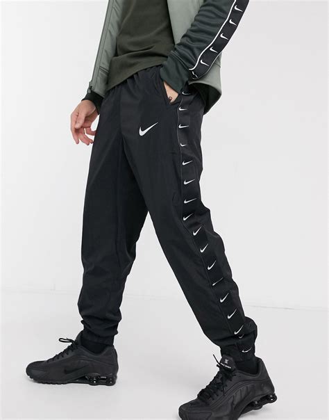 Nike Synthetic Woven Taping Cuffed joggers in Black for Men - Lyst