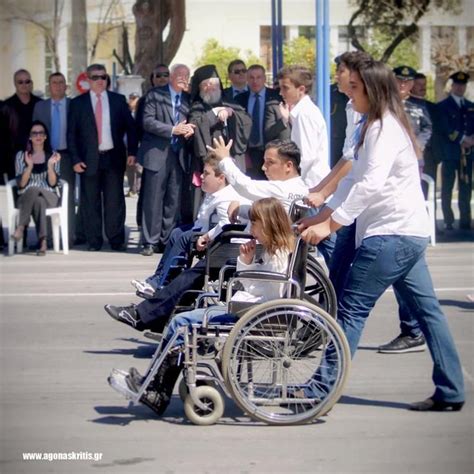 25 March Parade in Greece. A handicap teenager gives the "moutza" (like showing the middle ...