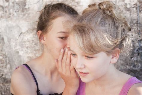 Girls whispering secrets stock photo. Image of rumors - 32031732