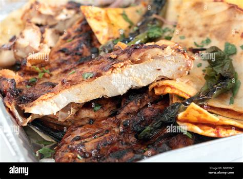 A restaurant tray of Turkish or Arab spatchcocked, marinaded grilled chicken, served with flat ...