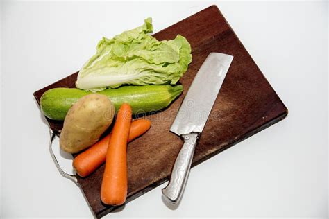 Vegetables On Chopping Board Stock Photo - Image of board, knife: 135406874