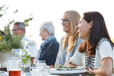 "Woman Laughing With Friends At Outdoor Dinner" by Stocksy Contributor ...