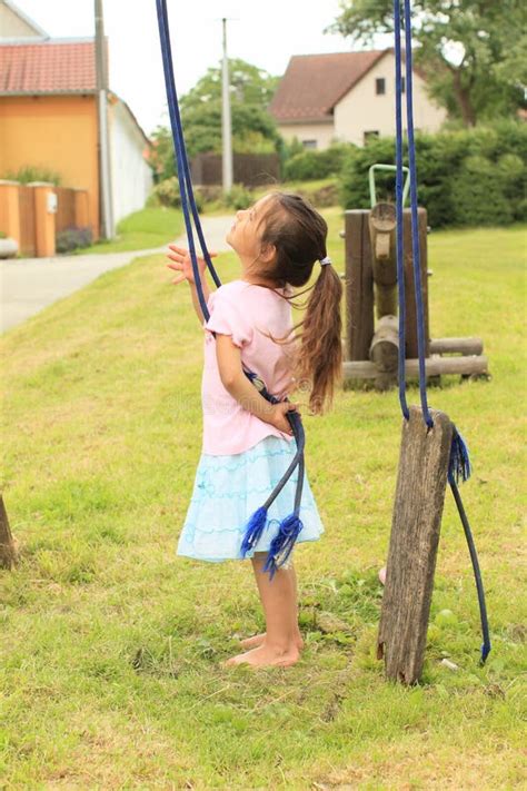 Girl Holding Rope of a Broken Swing Stock Photo - Image of child, playground: 32826678