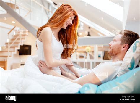 Romantic couple in love lying on bed Stock Photo - Alamy