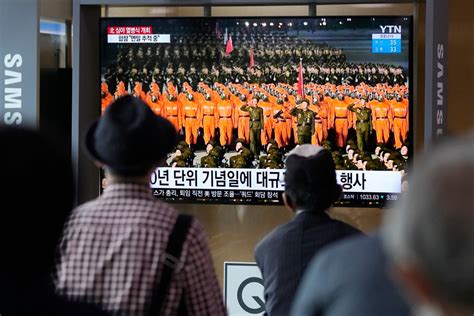 North Korea stages pared-down military parade featuring hazmat suits ...