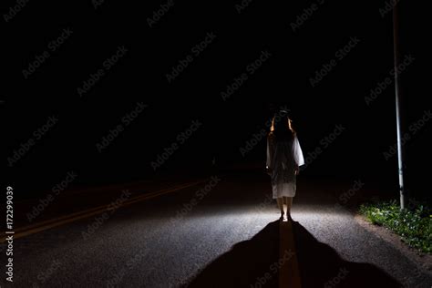 Mysterious Woman, Horror scene of scary ghost woman standing outdoor on street with light Stock ...