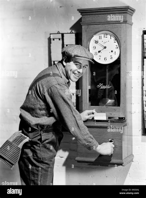 Person punching time card clock Black and White Stock Photos & Images ...