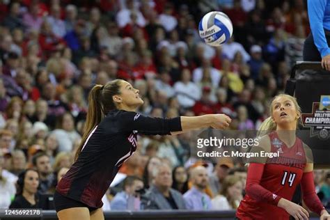 Elena Scott of the Louisville Cardinals digs a ball against the Texas ...