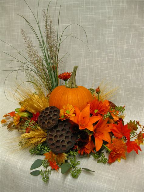 Fall centerpiece with a pumpkin in the middle. | Fall flower arrangements, Fall floral ...